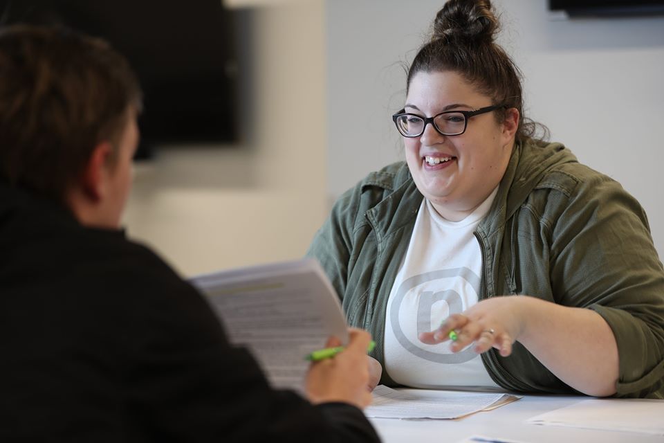 Nelnet associate smiling while discussing work