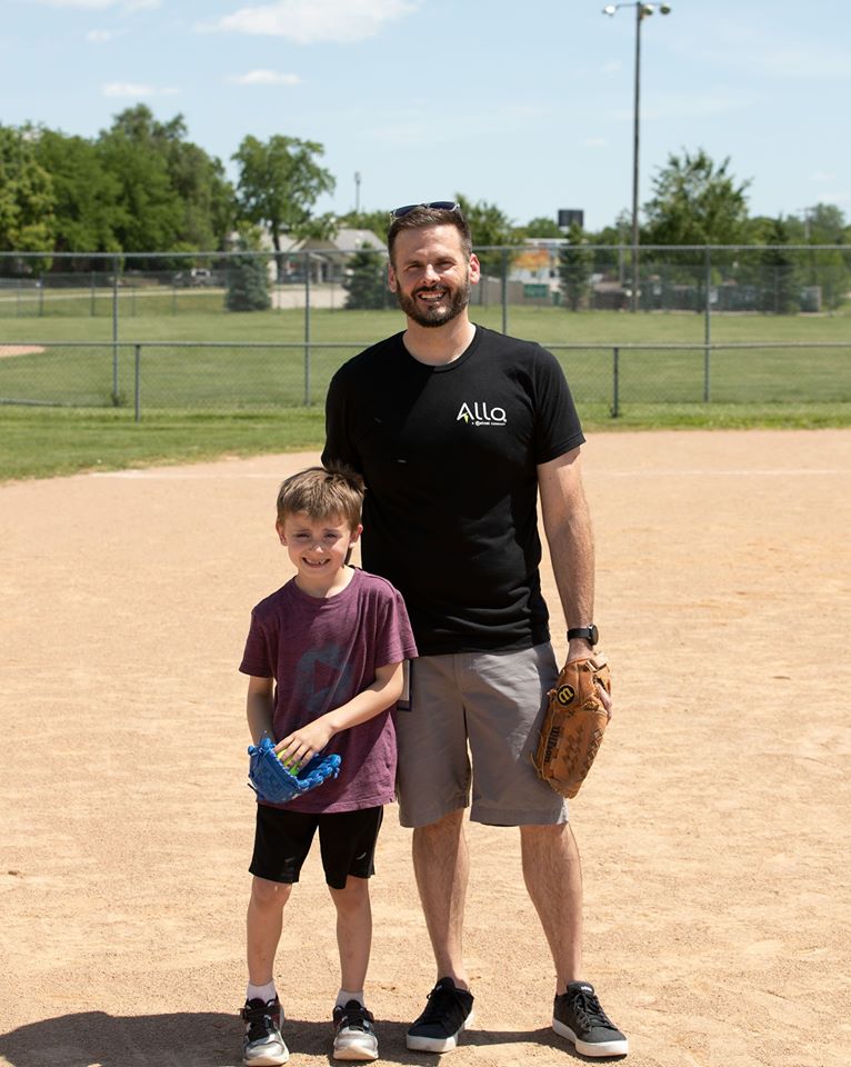 Nelnet associate and his son posing on baseball diamond